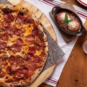 aria dining five50 tablescape pizza beer.jpg.image .2480.1088.high